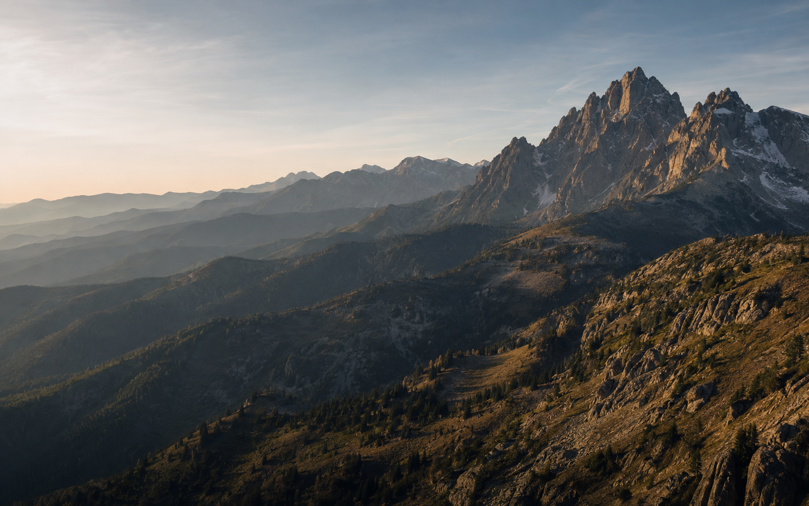 Layered mountain peaks at sunrise